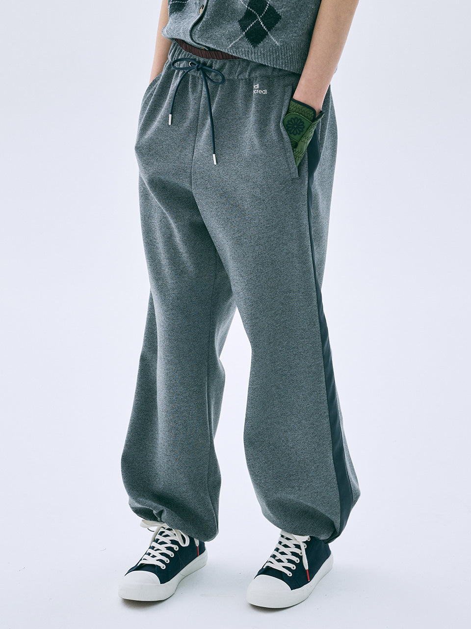 Person wearing gray sweatpants with a white background