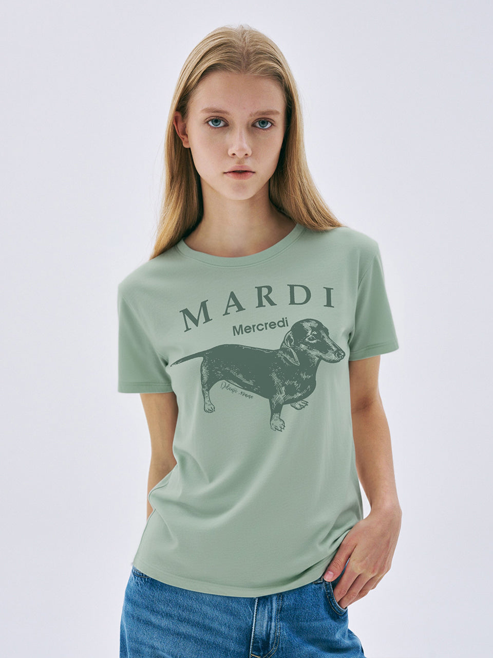 Person wearing a green t-shirt with a dog graphic and 'MARDI' text on a white background