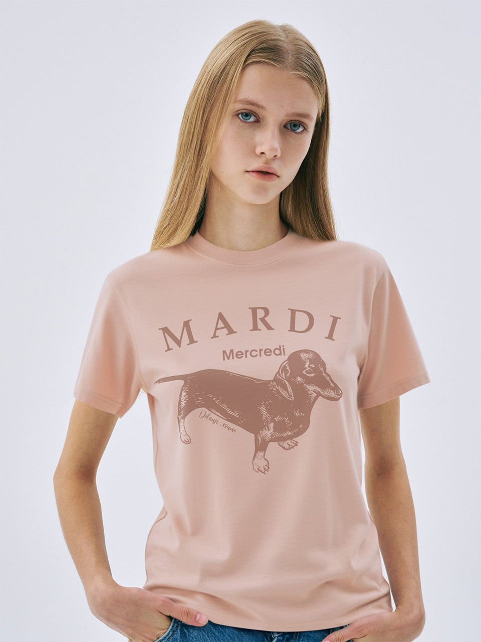 Person wearing a pink t-shirt with 'Mardi' and a dachshund graphic on a white background