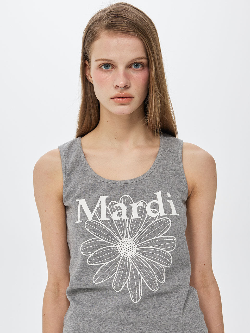 Woman wearing a gray tank top with a white flower and 'Mardi' text on a light gray background