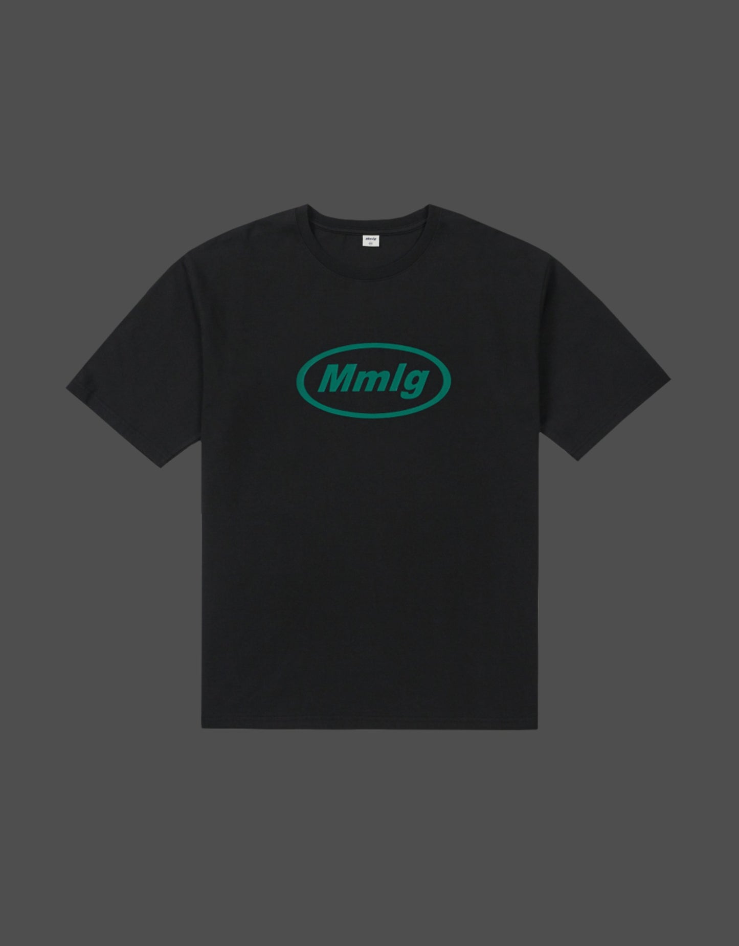 A black short-sleeve crewneck t-shirt with a teal-green oval 'Mmlg' logo printed on the chest, displayed against a dark gray background.