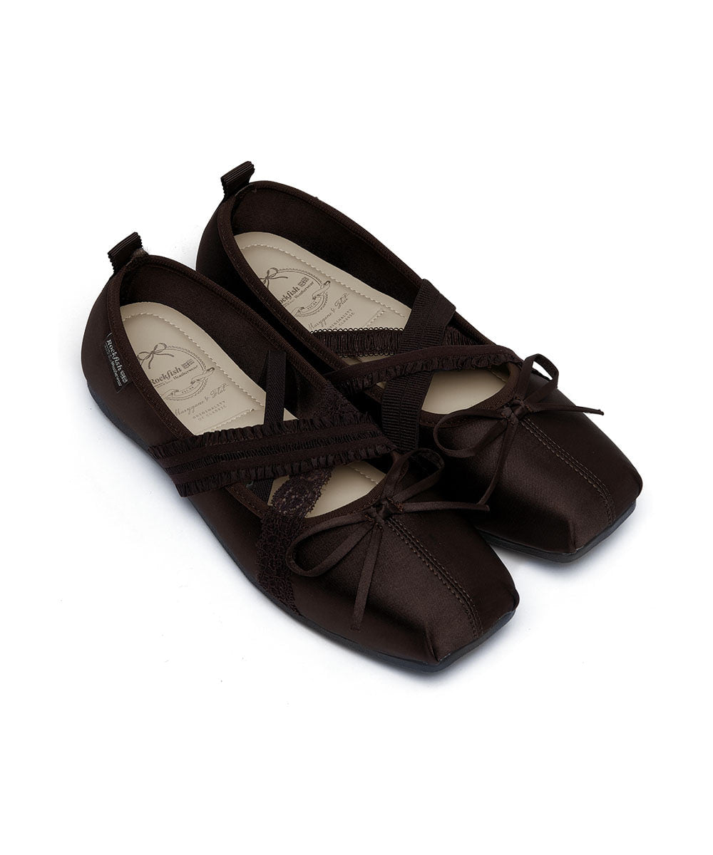 Pair of brown ballet flats with bow details on a white background