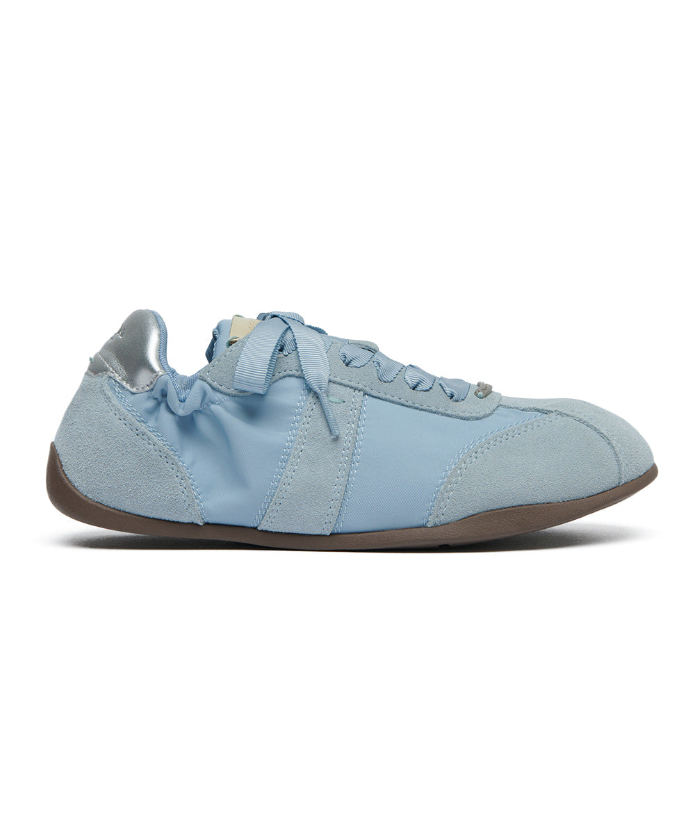 Light blue sneaker with brown sole on a white background