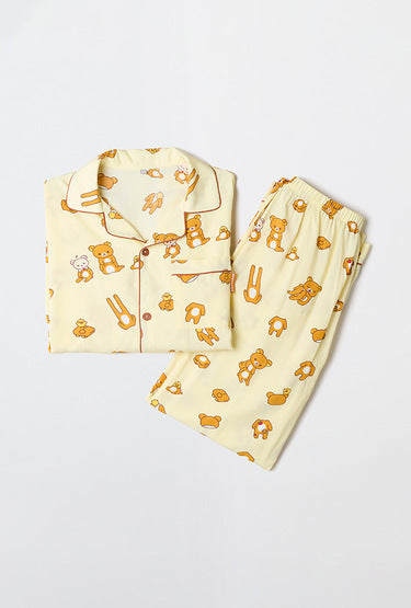 Yellow pajama set with teddy bear pattern on a white background