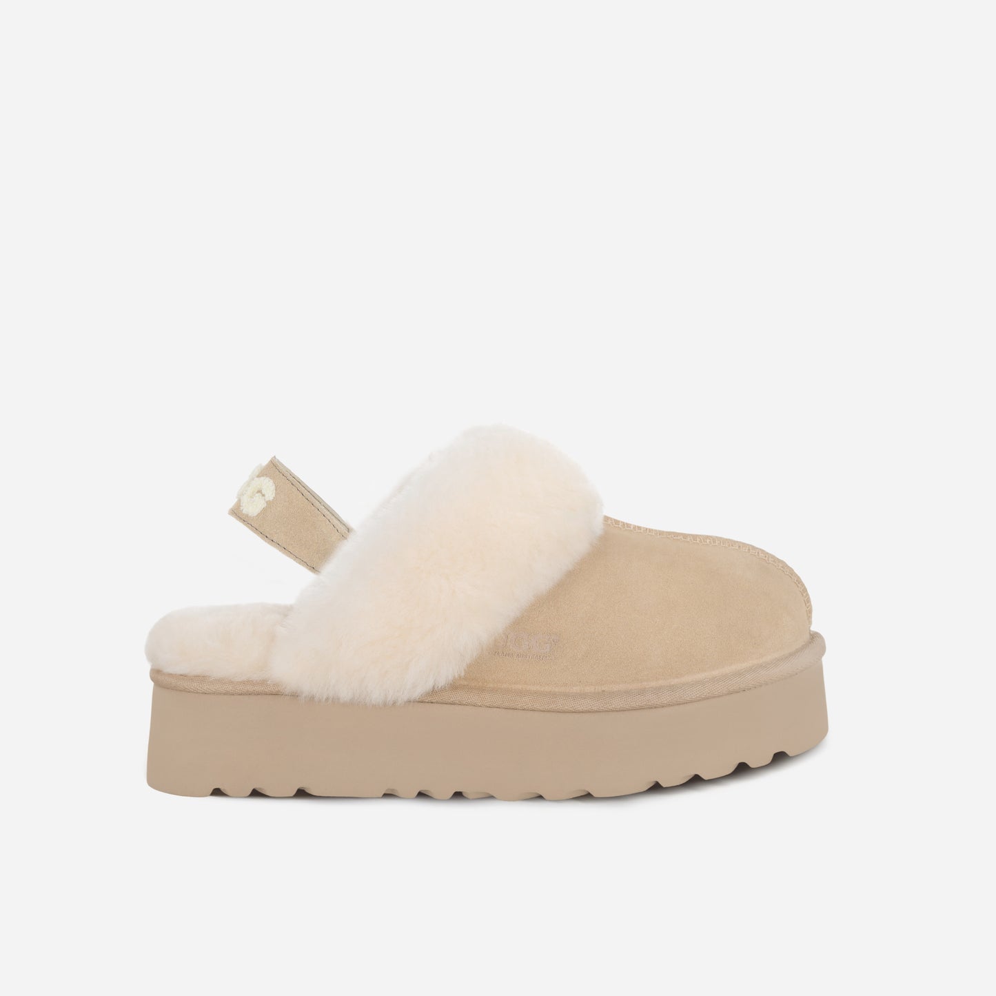 Beige platform slipper with white fur lining on a light gray background