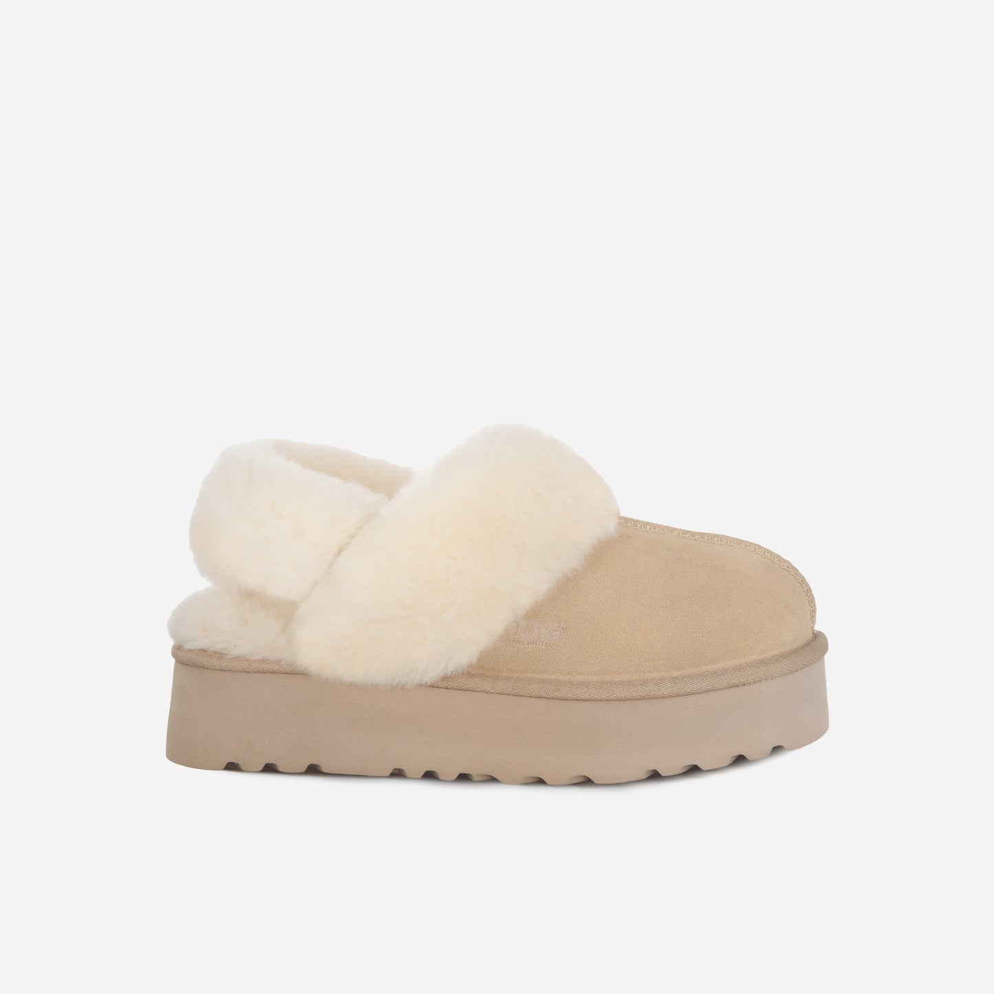 Beige and white slip-on platform shoes on a white background